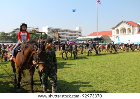 BANGKOK - JANUARY 14 :Children’s day, Unidentified children age about 8 year old are Riding Horse on field at Royal Thai Army Headquarters, on January 14, 2012 in Bangkok Thailand.