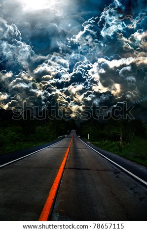 asphalt road and dark thunder clouds over it