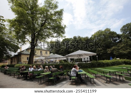 MUNICH, GERMANY - JUNE 28, 2013: Beer Garden at the English Garden in Munich. The English garden with his beer garden is very popular by local people and tourists.