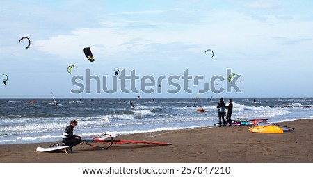 SCHEVENINGEN, NETHERLANDS - MAY 7, 2014: A group of kiteboarders are surfing the Dutch North Sea coast at Scheveningen.