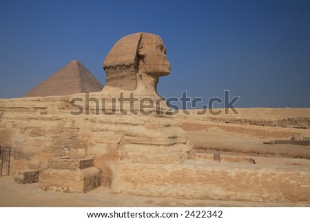 The great egyptian Sphinx of Giza with ancient pyramids on the background