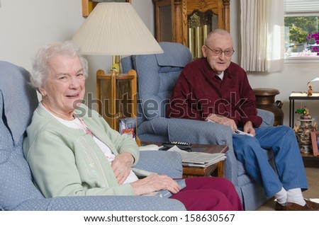 A happy elderly welcomes the viewer to their home.