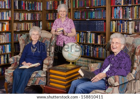 A group of elderly women in an assisted living\'s residence library
