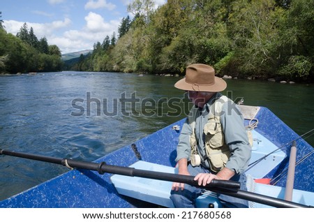 A fisherman looks down the Mckenzie River from his drift boat near Eugene Oregon.