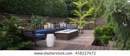 Panorama of a contemporary outdoor conversation inspired by oriental design.