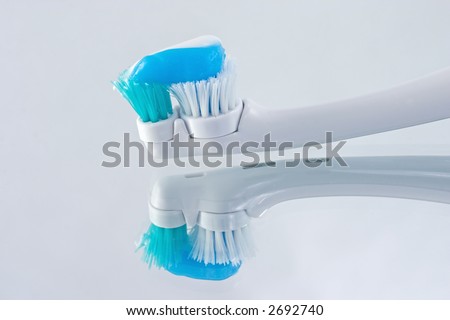 reflections of an electric toothbrush ready to use