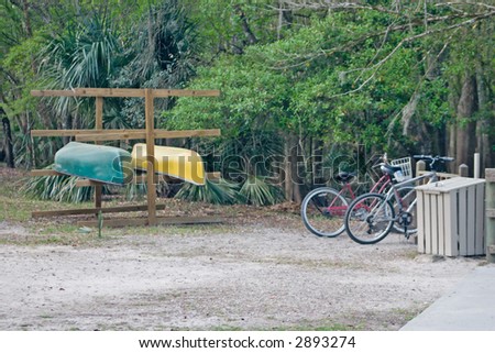 canoes on rental rack and nearby bikes in a rack show nature friendly modes of transportation for ecotourism