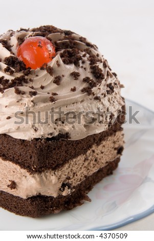 detail of a chocolate mousse cake with cherry
