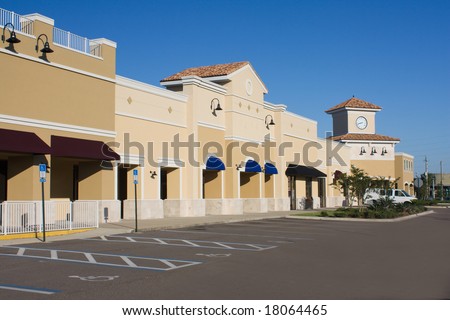 upscale pastel strip mall with awnings and corner clock tower