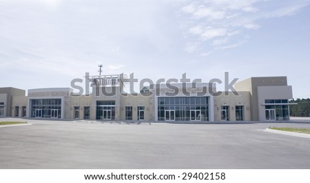 panoramic beige, brown and white strip mall with stone accents