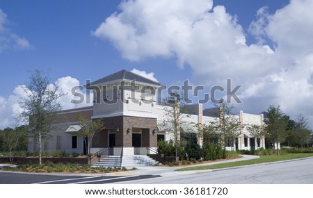 small retail strip mall with lush landscaping