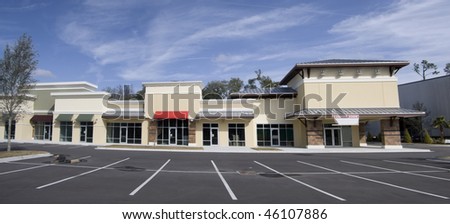 stitched panoramic of an upscale storefront mall with tin roof and colorful awnings