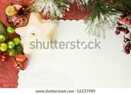 blank Christmas card with white star candle, sleigh bell, berry accent, icy foliage and copyspace