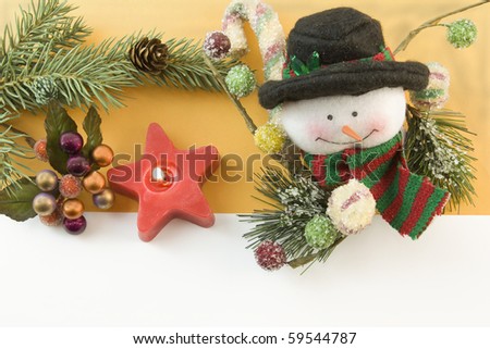 Chrismtas snowman with icy gumdrops, red star candle, fir branch, berry accent and copyspace