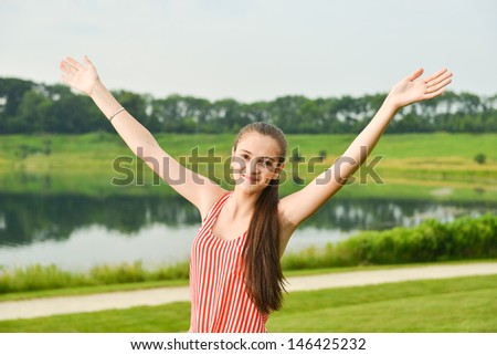 Woman holding up arms for winning, success, excitement, and joy