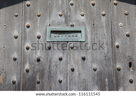 Fragment of an old English doors with mail slot
