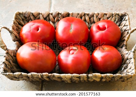 Ripe big tomatoes in a basket