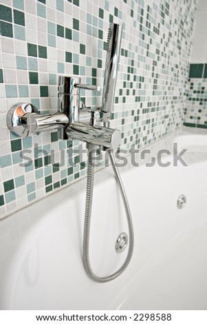 modern chrome tap in a green bathroom