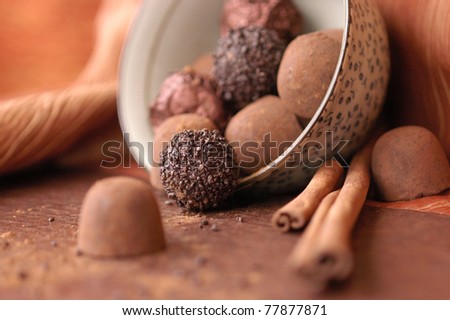 chocolate candy in a blue bowl on brown napkin