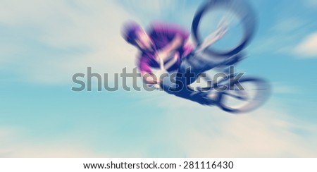 Abstract background . Boy on a BMX mountain bike jumping. Motion blur photo