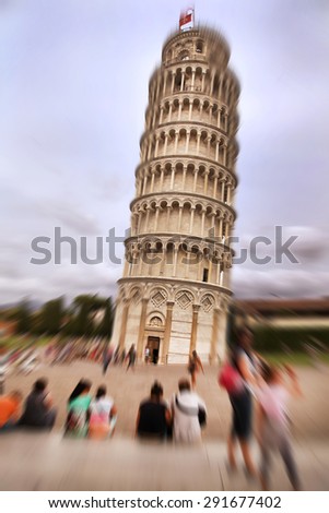 Abstract background. People on the background of the Leaning Tower.  Radial zoom blur effect defocusing filter applied, with vintage instagram look.