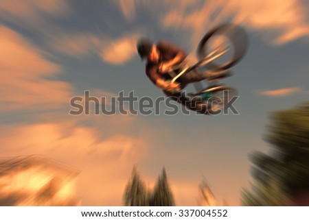 Abstract background . Boy on a BMX mountain bike jumping. Motion blur photo