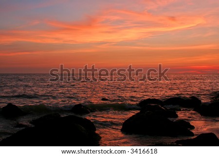 Vivid sunset and rocks on Florida Gulf Coast.