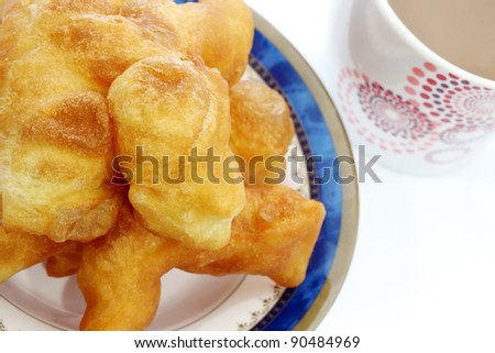 Deep-fried dough stick and coffee