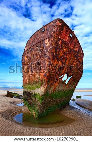 Deserted rusty ship on the coast of a ocean