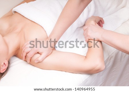 A qualified therapist doing a pressure point massage to relax  a woman\'s shoulder