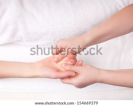 Qualified therapist doing therapeutic palm massage