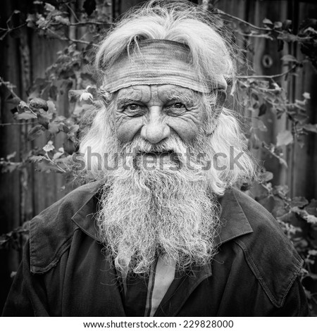 Charming senior old man with expressive eyes in black and white