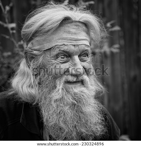 Charming senior old man with expressive eyes in black and white
