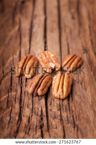 Pecan nuts on old wooden background