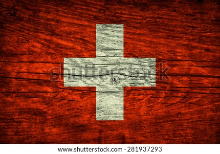 Vintage flag of Switzerland on wooden surface