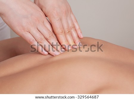 Close up of connective tissue massage on  a muscle group  of a woman\'s back
