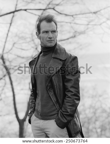 Pensive guy portrait. Trench coat. Outdoor shoot