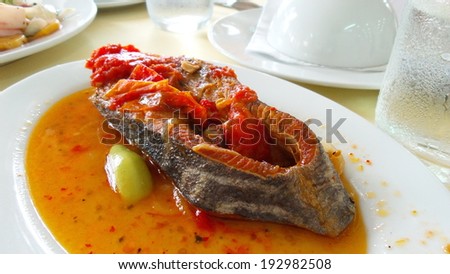 Fried fish topped with chili sauce