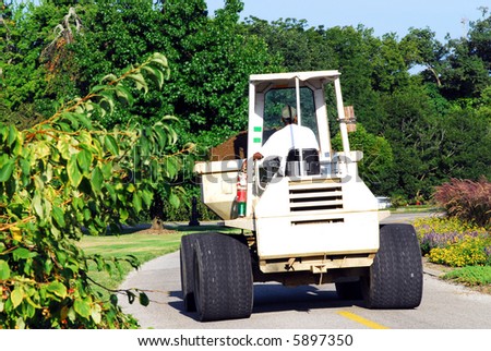 man operating front loader doing cemetery maintenance