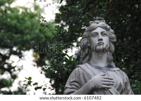 cemetery monument weathered stone statue of a  woman