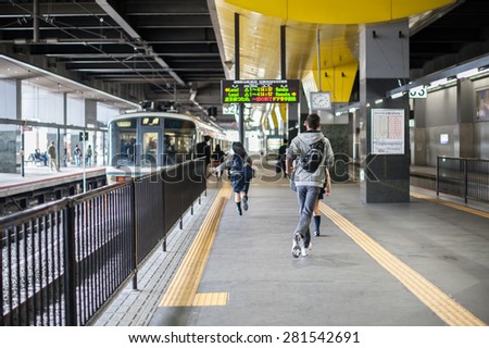 Kyoto, Japan - September 27, 2014: Student running to the train at train station, Japan.