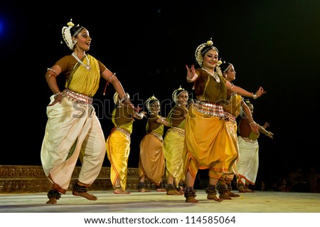 KONARK, INDIA - SEPTEMBER 24: An unidentified group of lady dancers wears traditional costume and performs Odissi dance at Konark temple on September 24, 2012 in Konark, Orissa, India