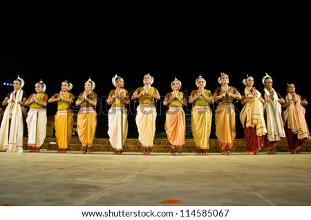 KONARK, INDIA - SEPTEMBER 24: An unidentified group of lady dancers wears traditional costume and performs Odissi dance at Konark temple on September 24, 2012 in Konark, Orissa, India