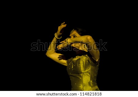 KONARK, INDIA - SEPTEMBER 24: An unidentified lady dancer wears traditional costume and performs Odissi dance at Konark temple on September 24, 2012 in Konark, Orissa, India