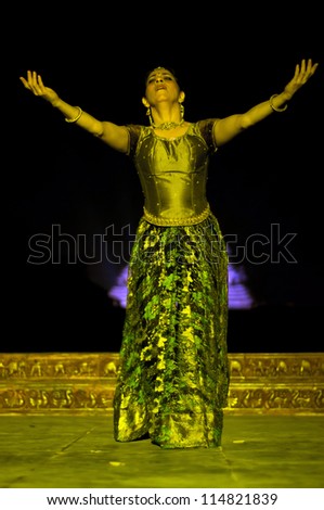 KONARK, INDIA - SEPTEMBER 24: An unidentified lady dancer wears traditional costume and performs Odissi dance at Konark temple on September 24, 2012 in Konark, Orissa, India