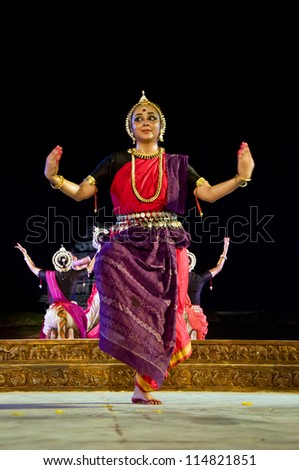 KONARK, INDIA - SEPTEMBER 24: An unidentified group of lady dancers wear traditional costume and perform Odissi dance at Konark temple on September 24, 2012 in Konark, Orissa, India