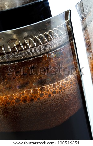 Close up photo of a Cafetiere with freshly brewed coffee inside, this is also know as a French press, Coffee plunger, Coffee press or Caffettiera.
