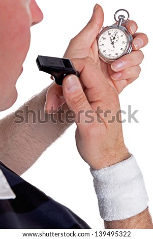 A referee checking his stopwatch and about to blow the whistle, isolated on a white background.