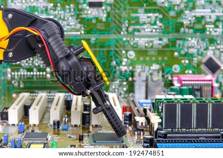 Robotic arm installing a computer chip