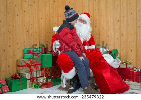 A boy visiting Santa in his grotto at Christmas.